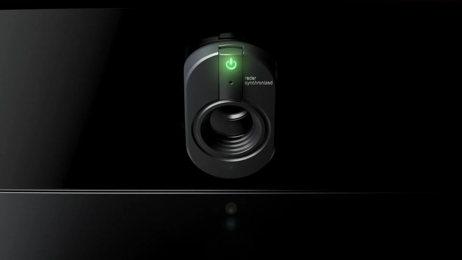 A black security camera with a green power indicator light labeled "radar synchronized" against a dark background.