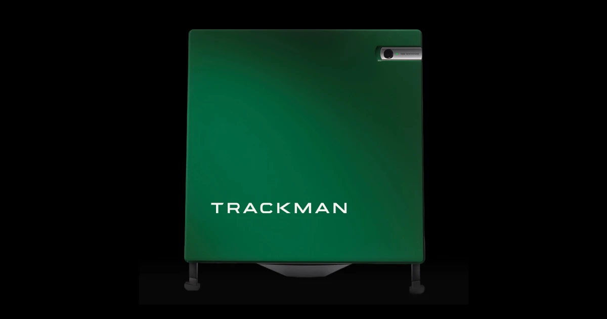 A green Trackman golf radar unit with a small camera on the top right corner, set against a black background.
