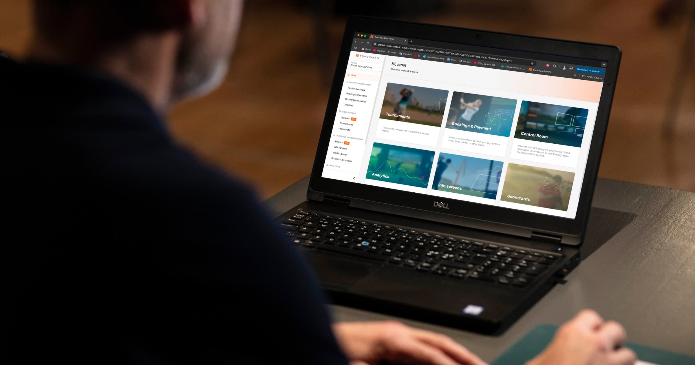 Person using a Dell laptop displaying a website Trackman Booking and Payments