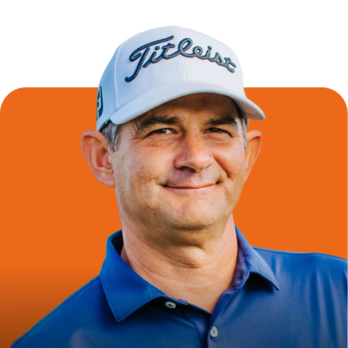 Man in a blue shirt and white Titleist cap smiling against an orange background.