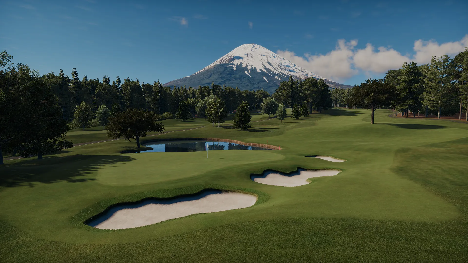Golf course with sand traps and a pond, surrounded by trees, with a snow-capped mountain in the background under a clear blue sky.