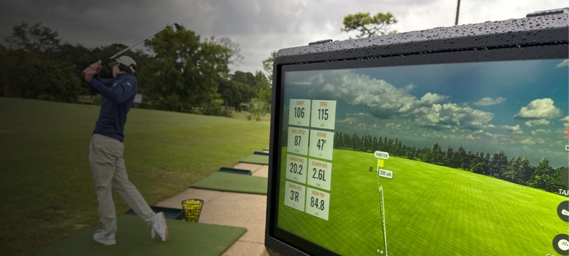 A person swings a golf club on a driving range, while a screen displays golf shot data including distance, speed, and launch angle.